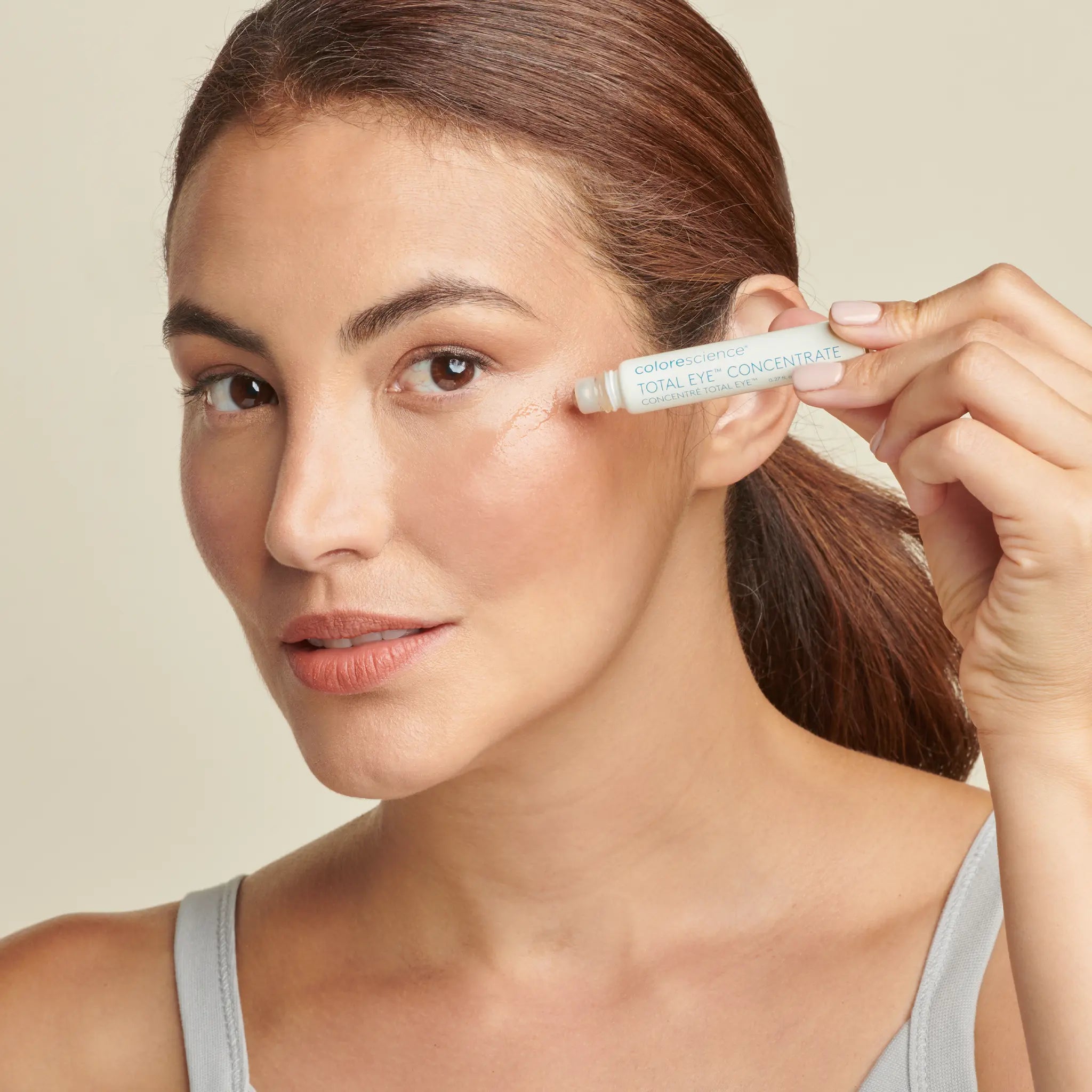 Woman applying Total Eye Concentrate Serum || all