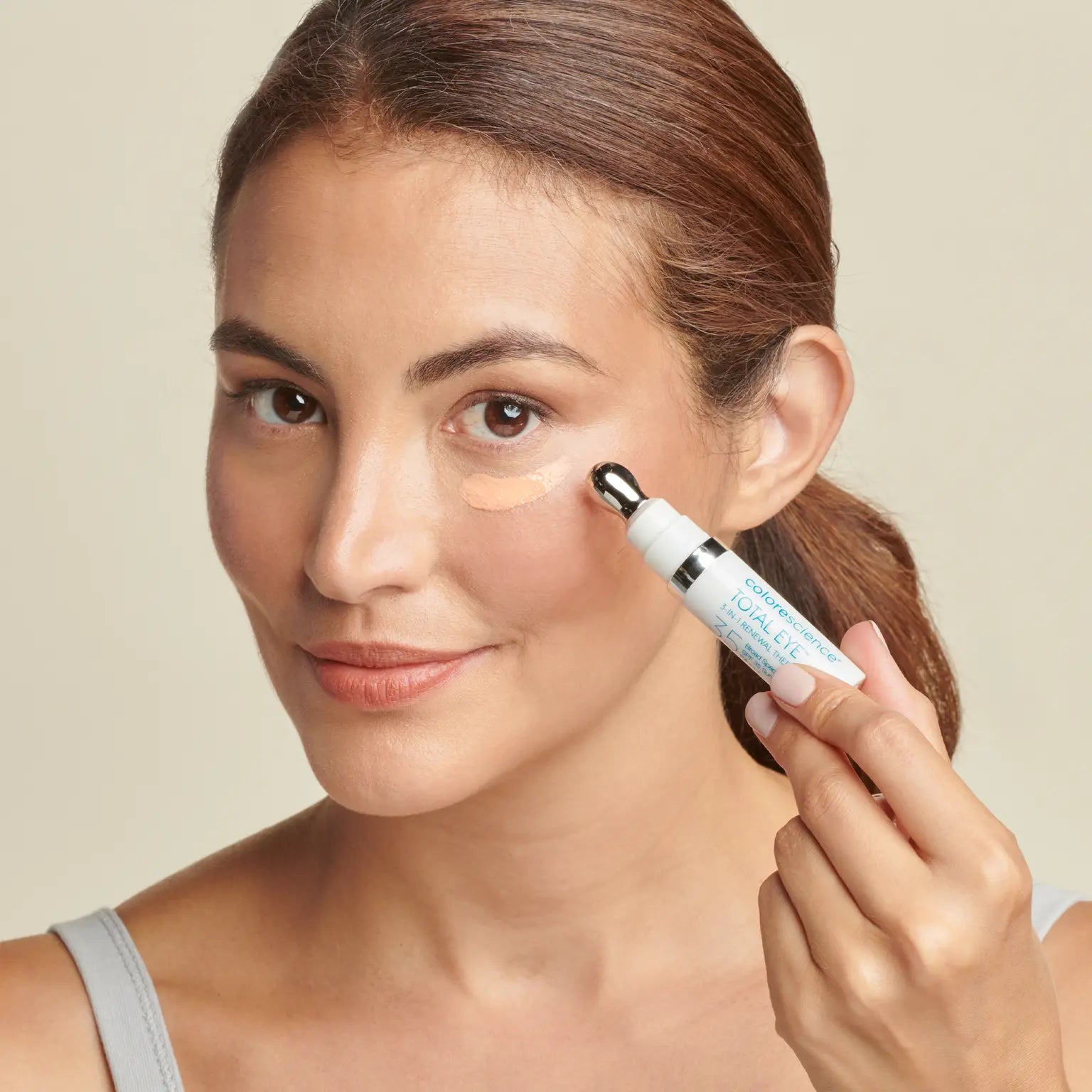 Woman applying Total Eye 3-in-1 Renewal Therapy SPF 35 || all