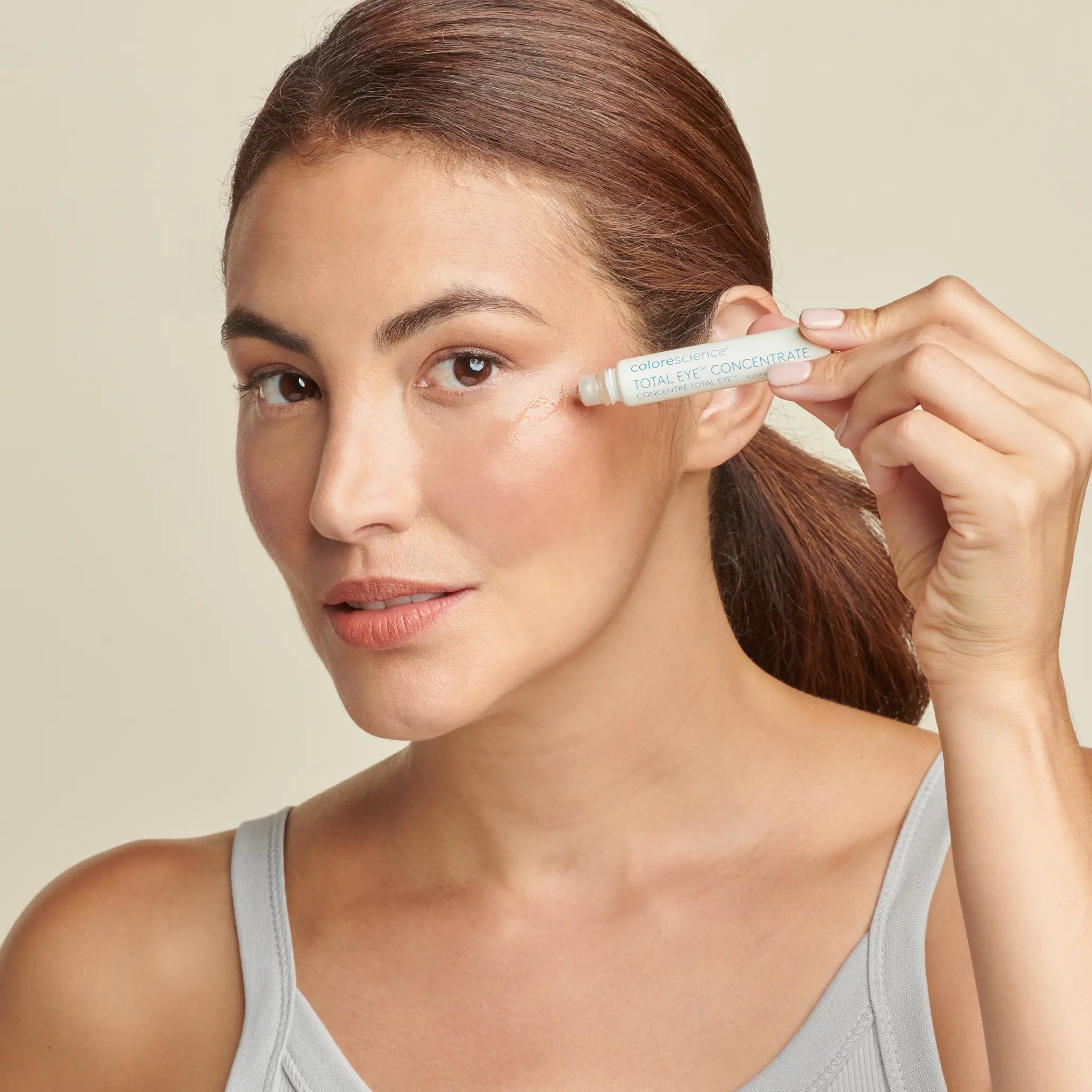 Woman applying Total Eye Concentrate Serum || all