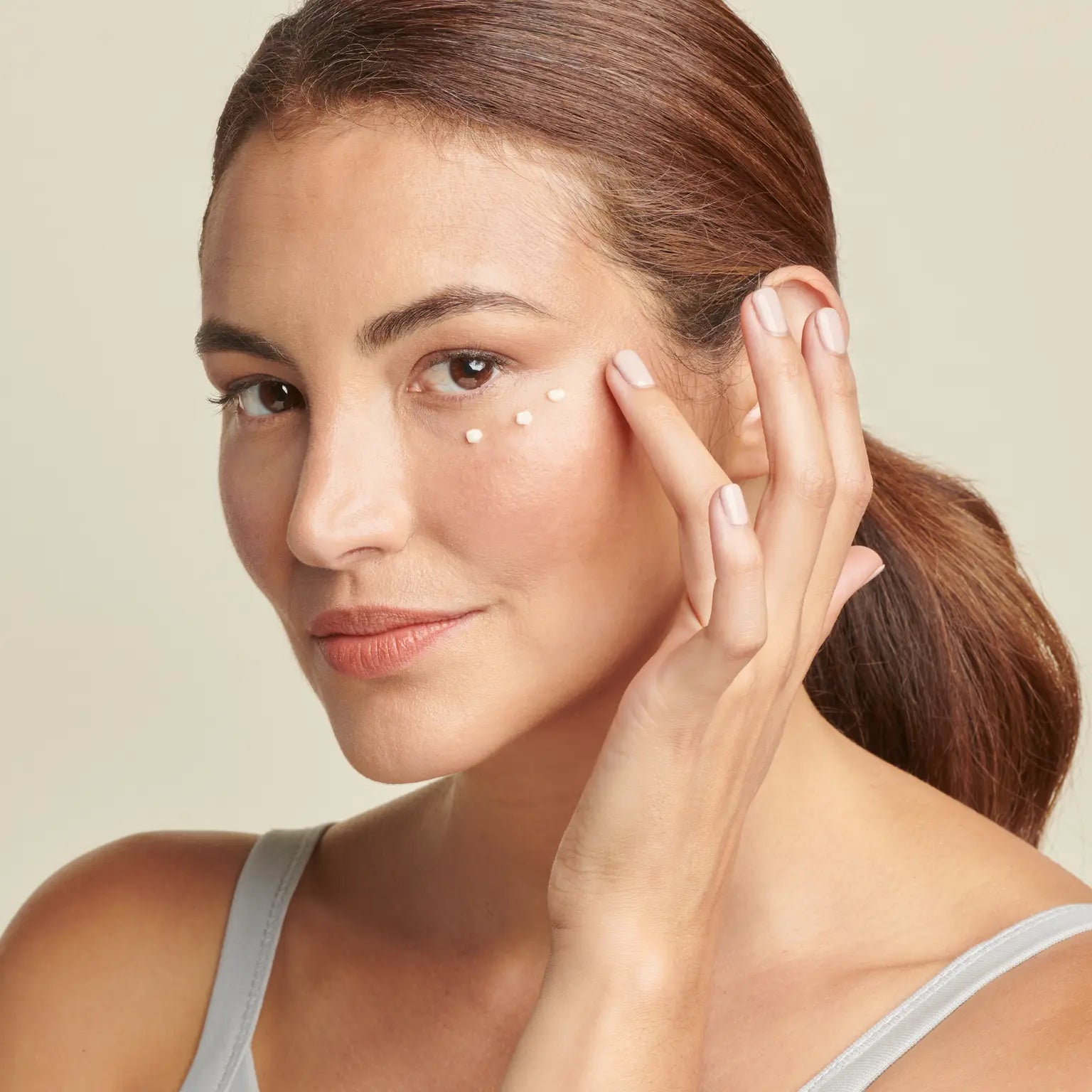 Woman applying Total Eye Firm & Repair Cream || all